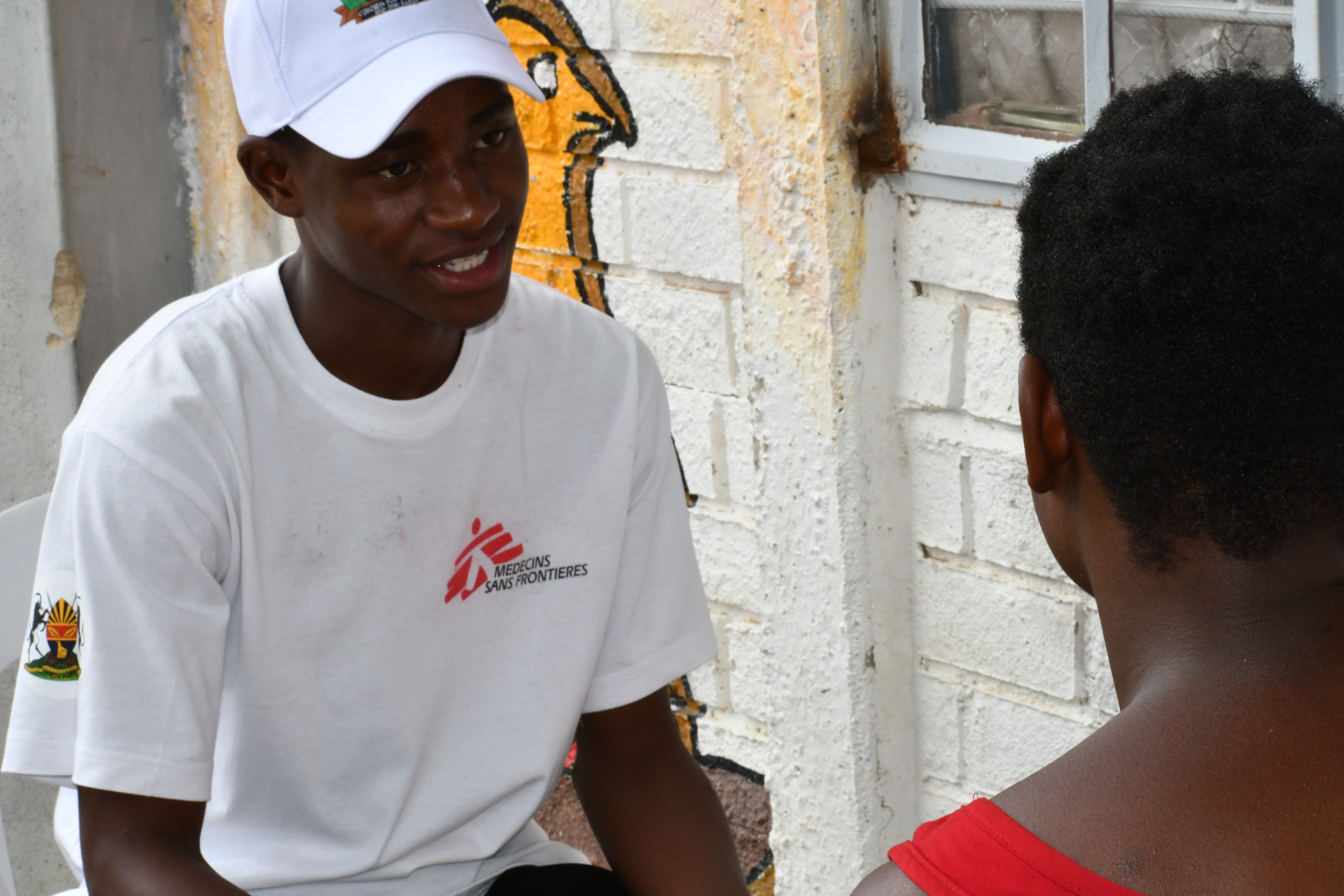 MSF worker talks to a patient