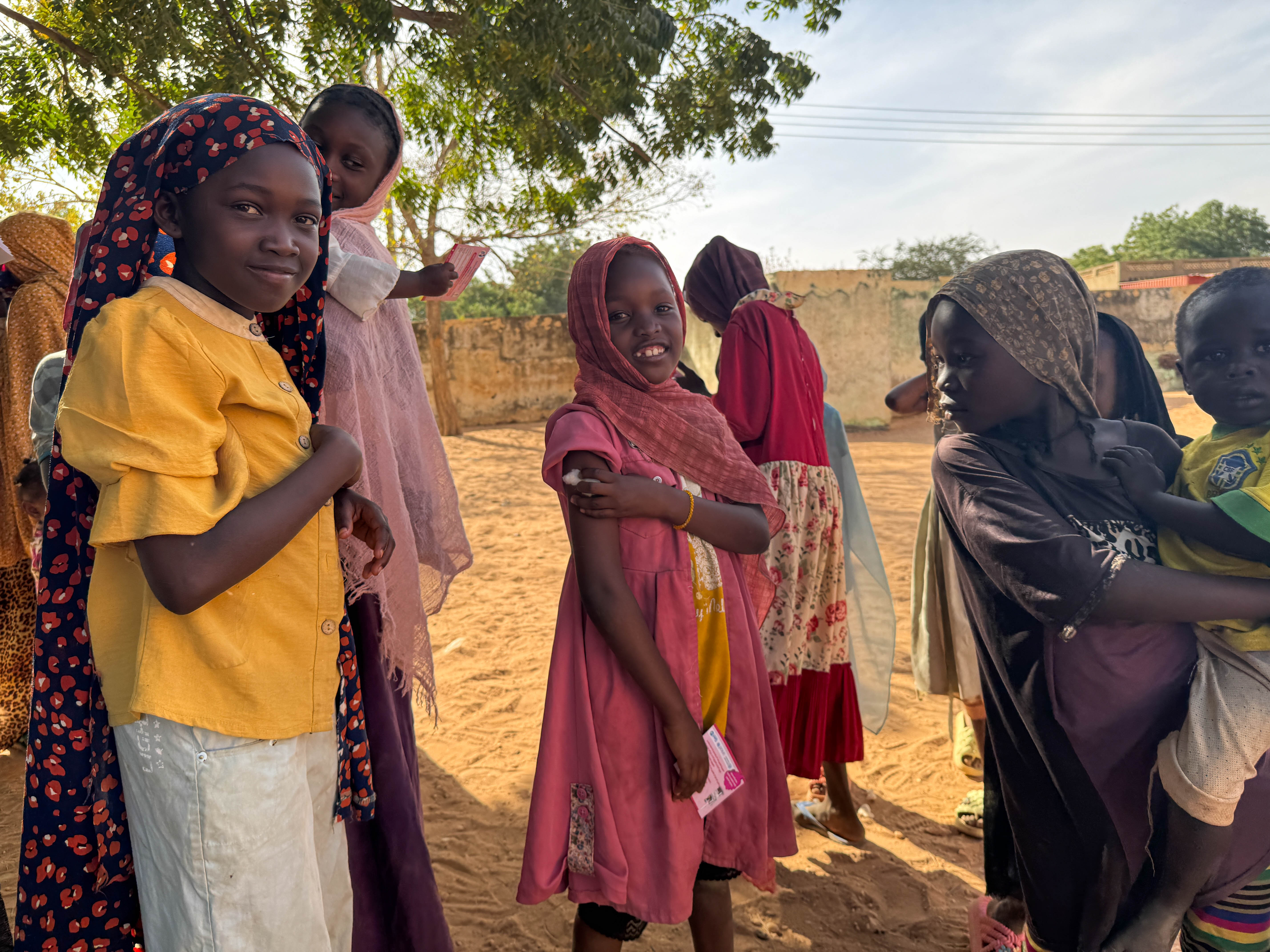 Ten-year-old Reem celebrates with a smile after receiving her measles and rubella vaccine in Alsafa, El Geneina. After showing her younger siblings that 'it only pinches and goes away quickly', Reem stood tall and encouraged her family.
