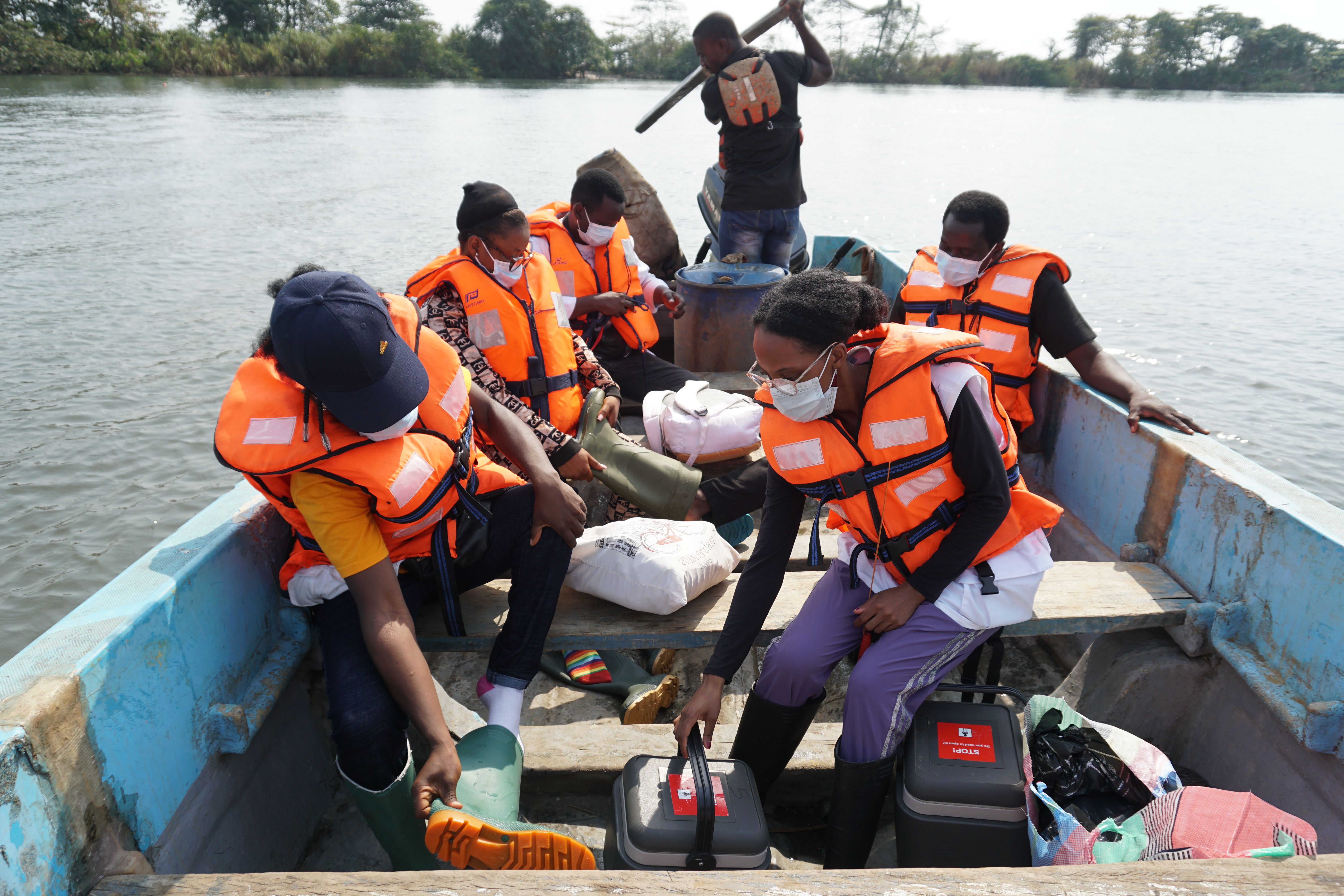L'équipe MSF composée d'un coordinateur d'urgence, d'un superviseur DMC, d'un responsable de la communication et de volontaires en santé communautaire, lors de la traversée en bateau depuis le village d'Enyenge où ils ont vacciné 419 personnes et qui se dirige maintenant vers le port d'Idenau. 