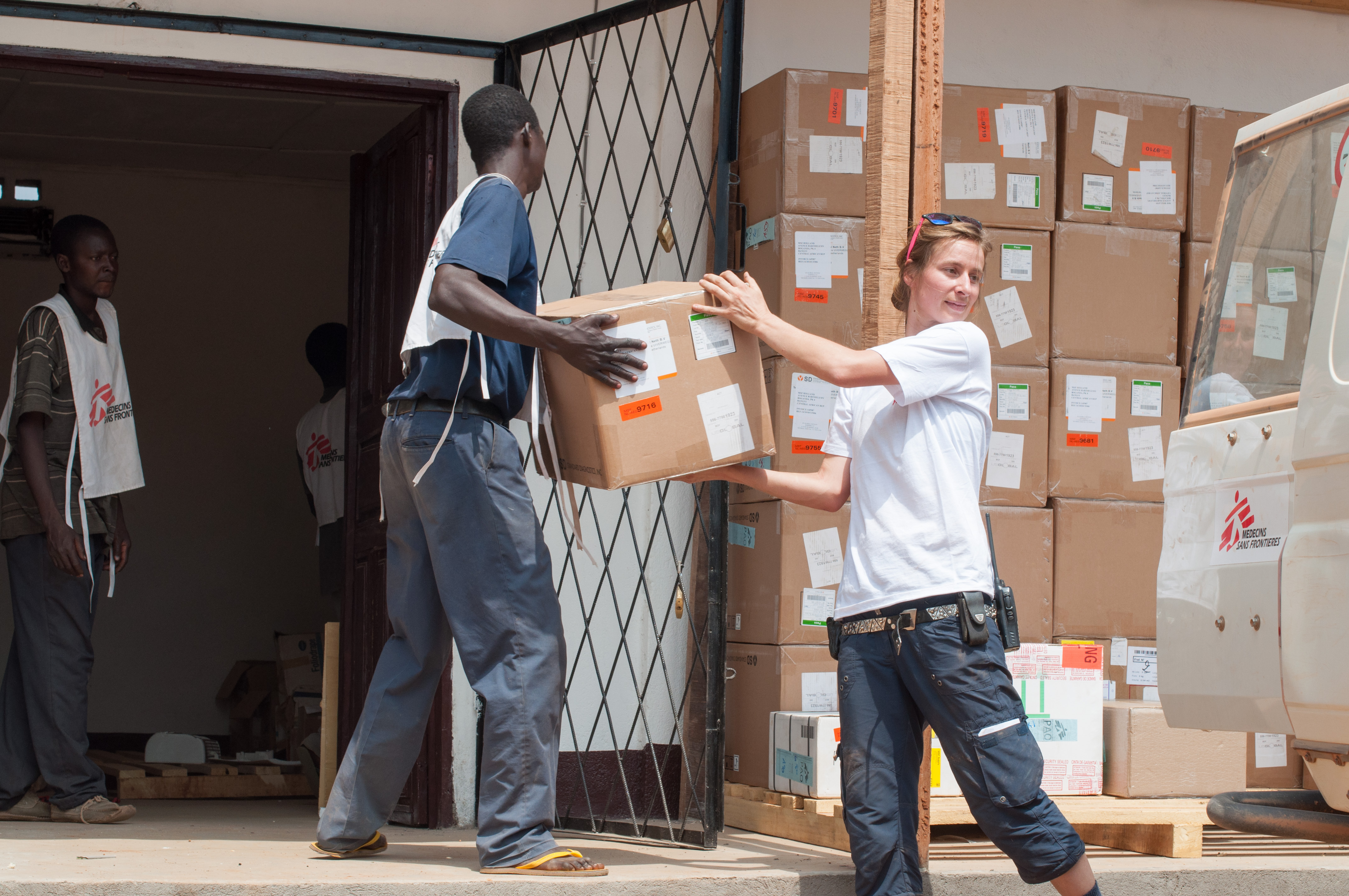 © Giorgio Contessi/MSF - MSF logistician Jennifer Bock and her colleagues store 58 boxes containing one ton of medical supplies, mainly malaria testing kits, destined for the MSF-supported health centre in Boguila, Central African Republic.