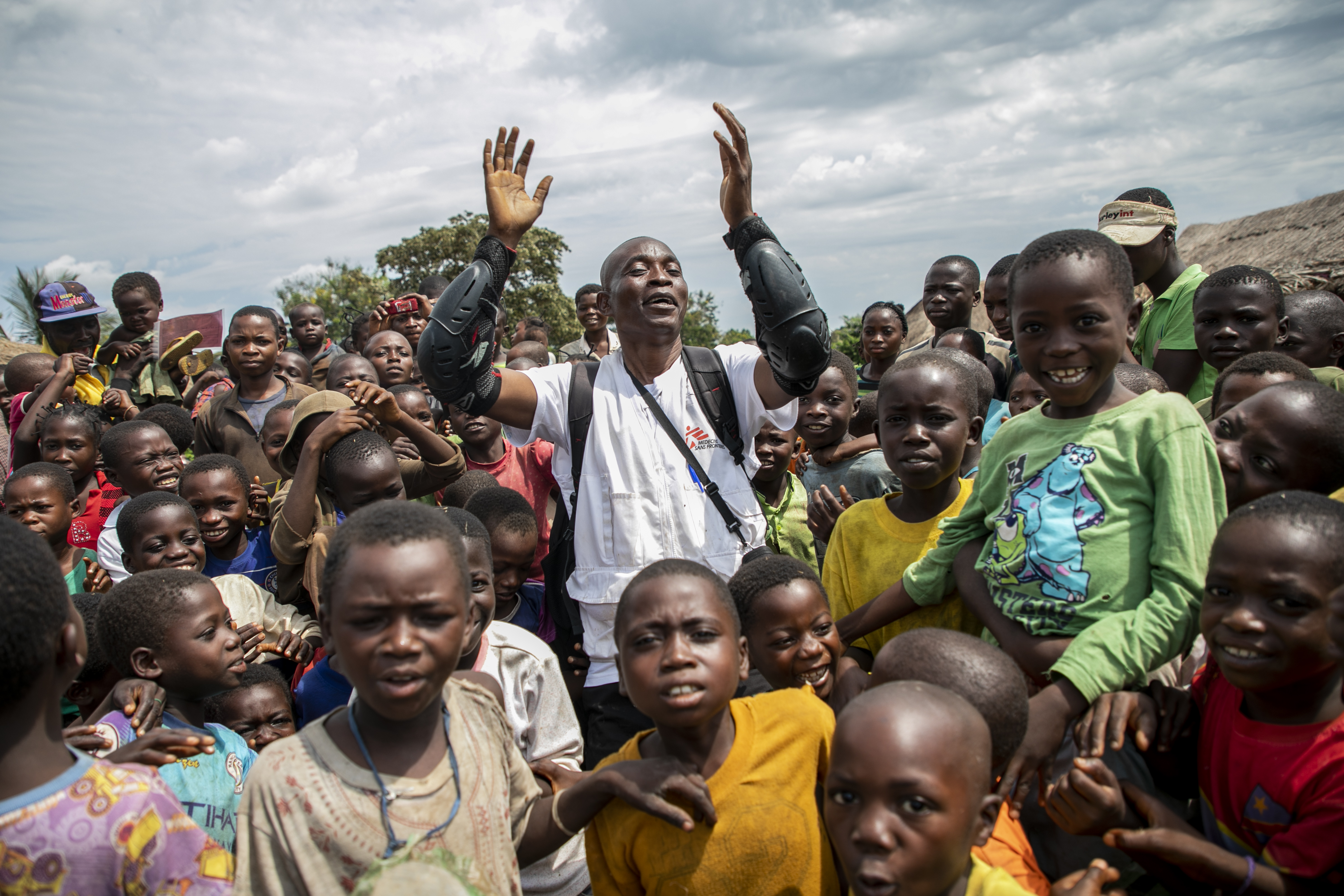 Papa Lazard, health promoter supervisor, sings a song to promote health values and popularity of the vaccine against measles at the Kweba village, Lungonzo district.