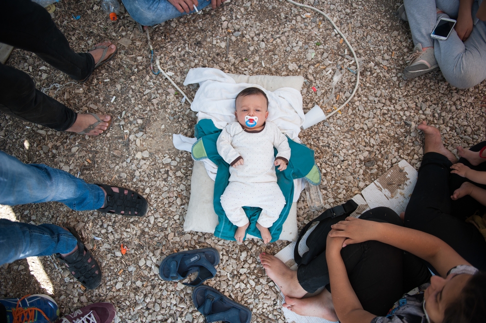 Een Syrische baby ligt op de vloer van het Kara Tepe-kamp. Zijn familie heeft geen melk voor hem, en geen geld om er te kopen. © Georgios Makkas/AZG