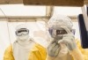 Twee medewerkers van Artsen Zonder Grenzen doen hun beschermende pakken aan om veilig te kunnen werken in een gebied waar ebola heerst. © AZG 